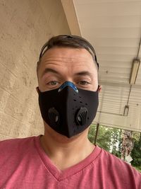 Portrait of young man covering face