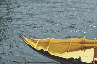 Close-up of yellow boat moored on water