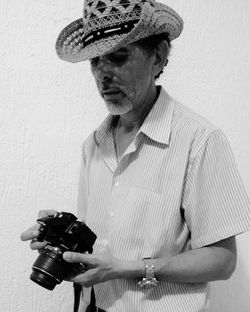 Close-up of man holding camera