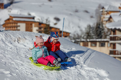 People skiing on snow covered mountain