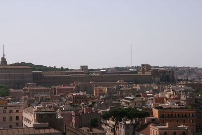 Houses in town against clear sky