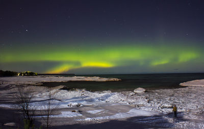 Scenic view of lake against sky at night
