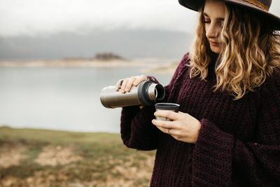 Young woman photographing with camera