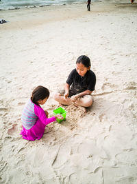 Children playing on sand at beach