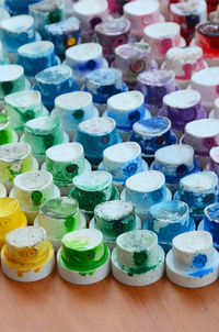 Close-up of abandoned spray bottle caps on table