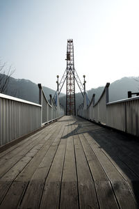 Footbridge against clear sky