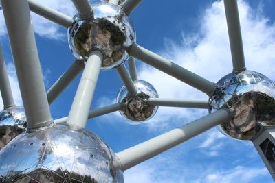 Low angle view of metallic structure against blue sky