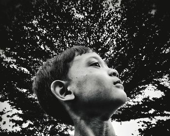 Low angle view of boy looking up