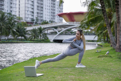 Portrait of young woman exercising in park