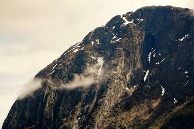 Close-up of snow on mountain against sky