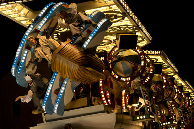 Low angle view of illuminated ferris wheel