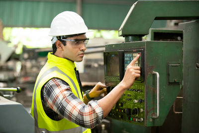 Rear view of man working in factory