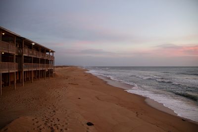 Scenic view of beach against sky during sunset