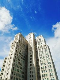 Low angle view of modern building against cloudy sky