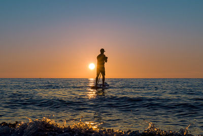 Standup paddle on sunset