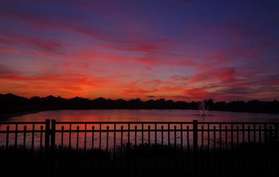 Scenic view of lake against romantic sky at sunset