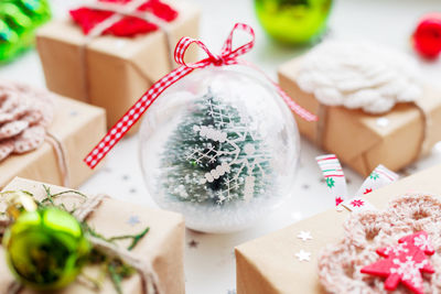 Christmas and new year background with decorations and transparent ball with fir tree inside.