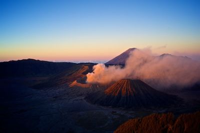 Smoke emerging from volcanic landscape