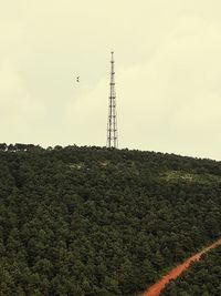 Low angle view of communications tower against sky