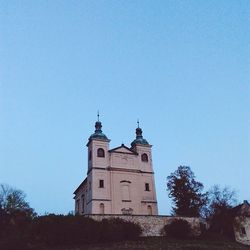 Low angle view of built structure against clear blue sky