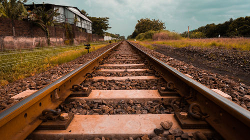 Surface level of railroad tracks against sky