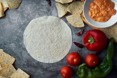 Preparing mexican fajitas with cakes, tomato, pepper, spicy and meat. concept of mexican food.