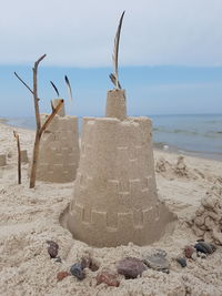 Close-up of sandcastles at beach