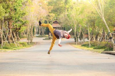 Full length of man performing stunt on road