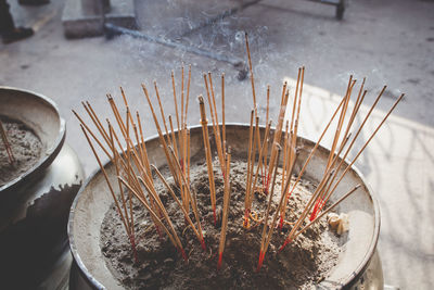 Close-up of incense sticks in container