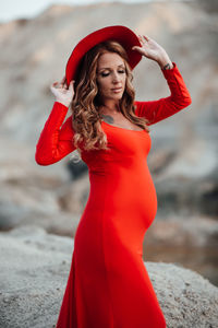 Portrait of beautiful young woman standing outdoors