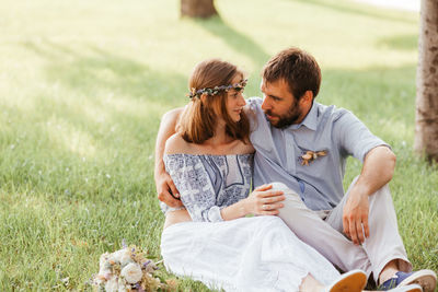 Couple sitting on grass outdoors