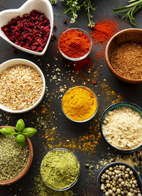 Colorful and aromatic herbs and spices on a dark background