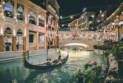 View of canal in city at night