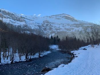 Scenic view of snow covered mountains against sky