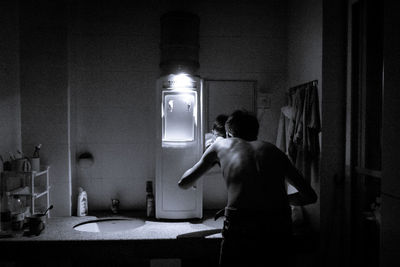 Rear view of man standing in corridor