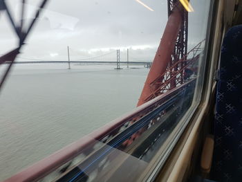 Blurred motion of bridge over sea against sky