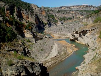 Scenic view of river amidst mountains