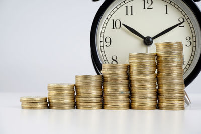 Stack of coins on table against white background