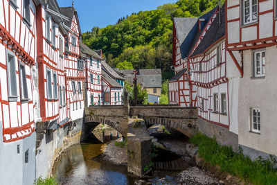 River elz with old bridge and half-timbered houses in monreal, germany