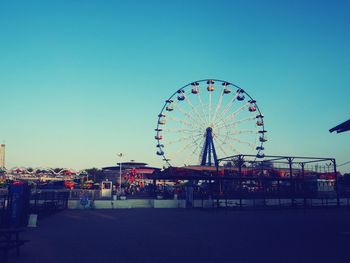 Ferris wheel against clear blue sky