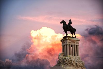 Statue against sky during sunset