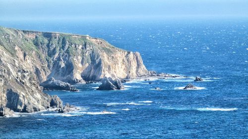 Scenic view of sea and rocks against sky