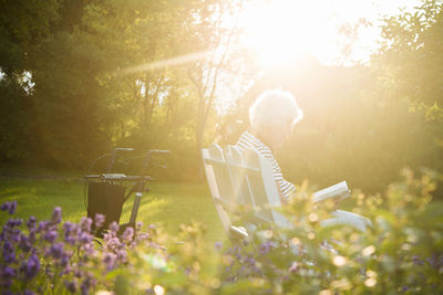 Senior woman reading book in garden