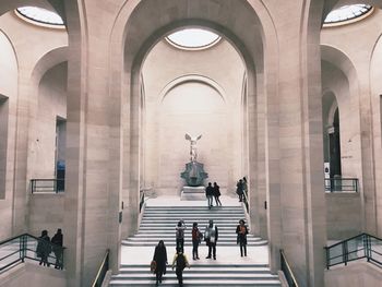 Tourists at entrance of historical building