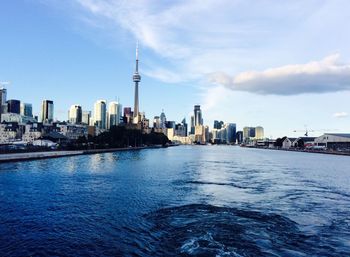 Lake in front of cn tower surrounded by illuminated cityscape