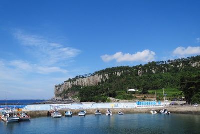 Boats moored in sea against sky