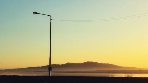 Scenic view of sea against clear sky during sunset