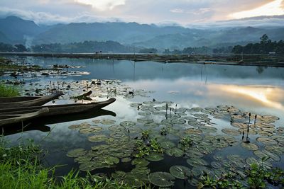 Scenic view of lake and mountains against sky