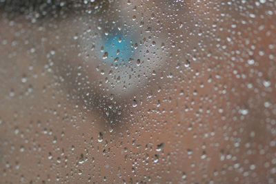 Full frame shot of wet glass window in rainy season