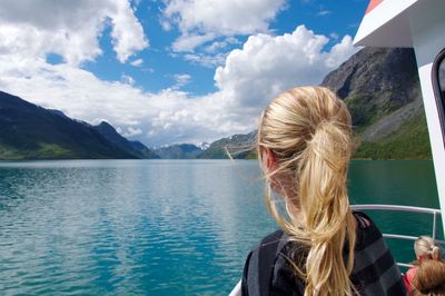 Rear view of woman on boat sailing in river